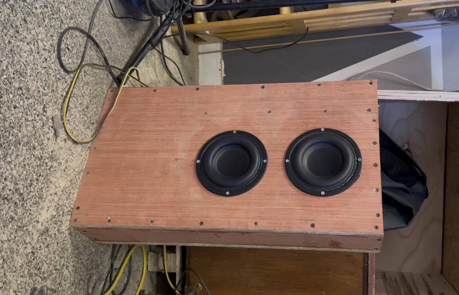 Custom wooden enclosure with two five inch subwoofers during Subaru Impreza sound system build